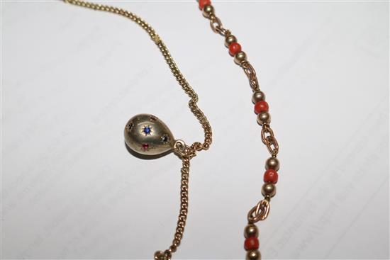 A 9ct gold necklace hung with four egg shaped charms and a 9ct gold and coral bead necklace.